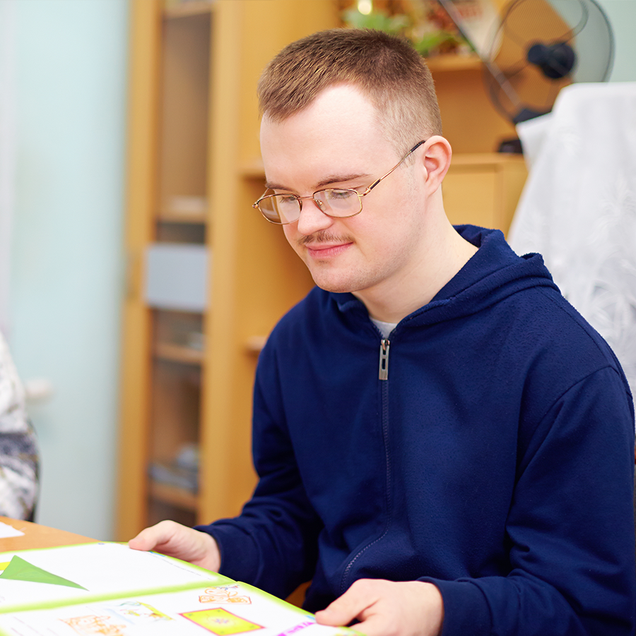 Man with a disability reading a book