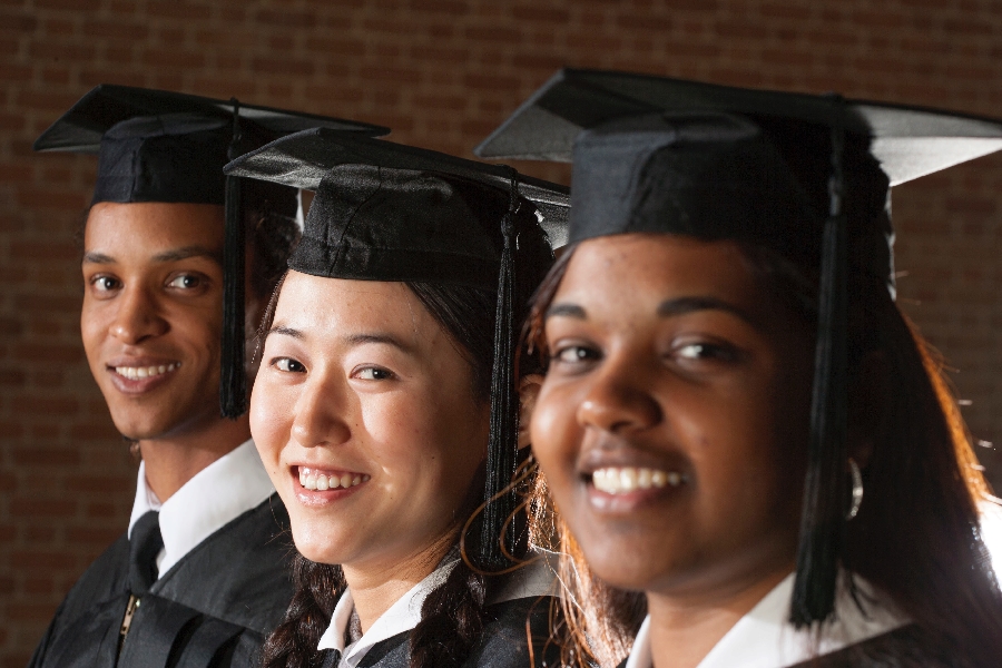 Three students wearing graduation caps