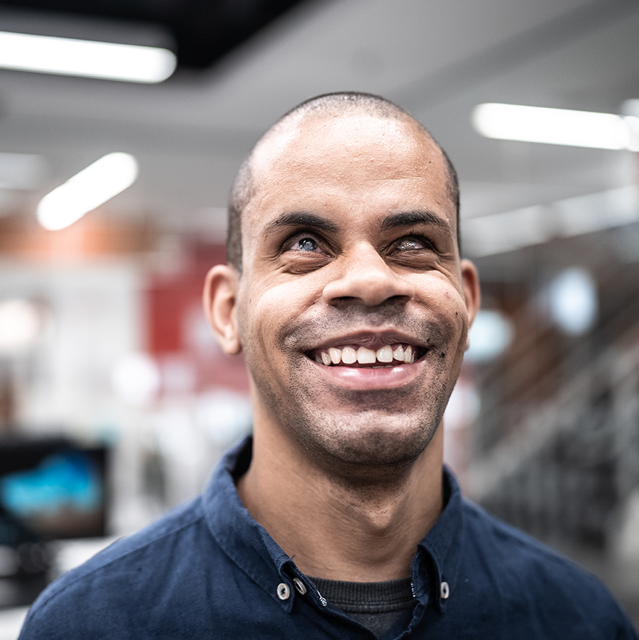 Smiling African American man who is blind.