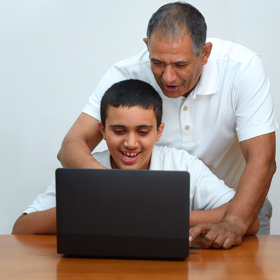 Father and son using a computer together